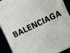 Balenciaga logo on textured white canvas background showcasing brand identity on fabric material