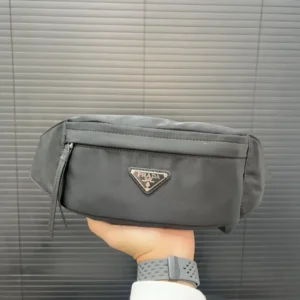 Prada Re-Edition 2005 small belt bag black nylon with leather trim and silver logo plaque