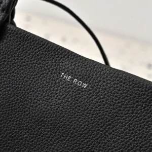 The Row handbag black pebbled leather luxury purse with minimalist design