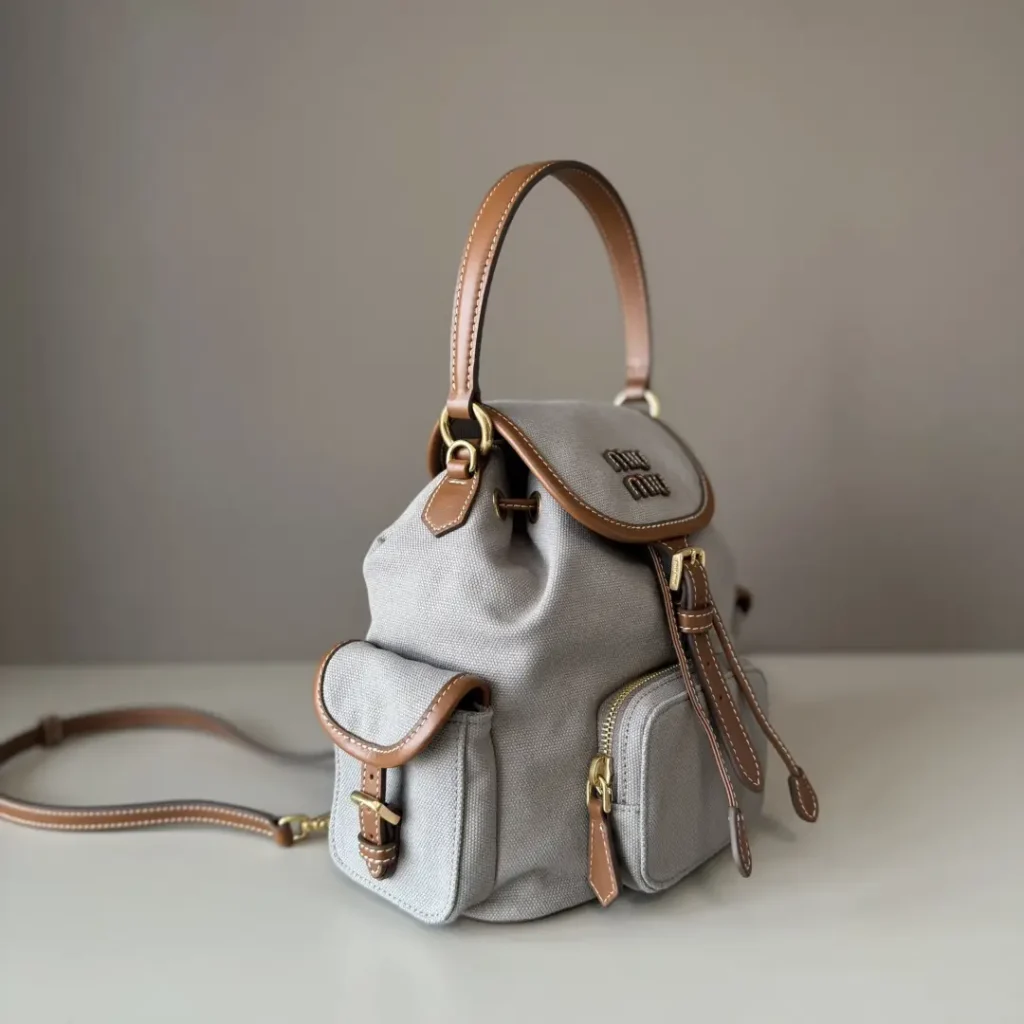 Miu Miu small backpack gray canvas brown leather trim gold hardware buckle closures