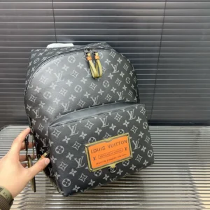 Louis Vuitton backpack medium size black monogram canvas with orange leather label and yellow zipper pull tabs