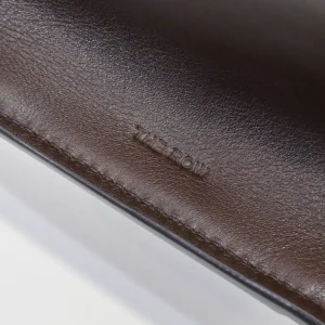 The Row leather bag dark brown smooth leather close-up embossed logo detail