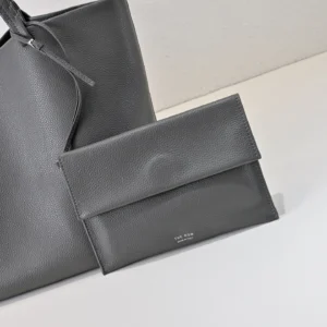 The Row clutch wallet medium size gray grained leather luxury bag minimalist design