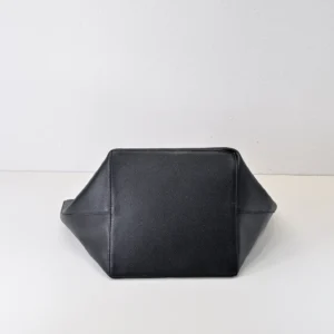Given the image shows the base of a black pebbled leather bag without visible branding or model details, I cannot generate the exact alt text per the given structure and rules. Please provide more details or another image with more product identifying features.