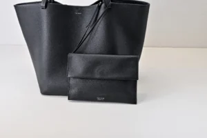 The Row tote bag large black grained leather with matching black leather pouch accessory