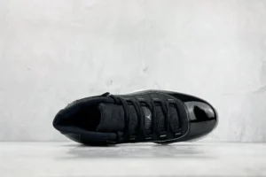 Nike Air Jordan 11 Retro Black patent leather and mesh sneakers with white midsole and black outsole