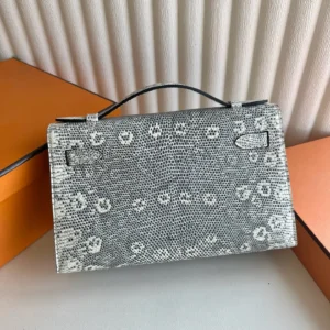 Hermès Kelly 25 bag white and black lizard leather with top handle and shoulder strap
