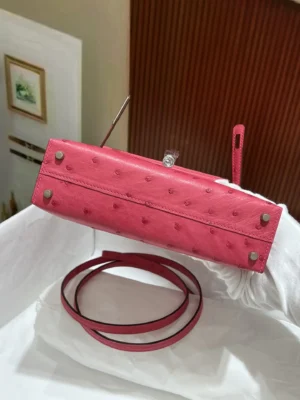 Hermès Kelly 25 bag fuchsia ostrich leather with silver hardware and detachable strap