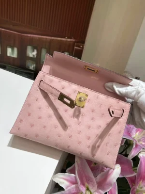 Hermes Kelly Pochette 22 light pink ostrich leather clutch bag with gold hardware