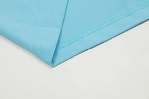 repsgoat cotton fabric close-up sky blue material with detailed stitching on white background