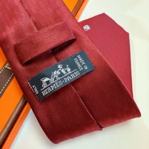 Hermes tie red jacquard silk tie made in France with signature horse and carriage logo label