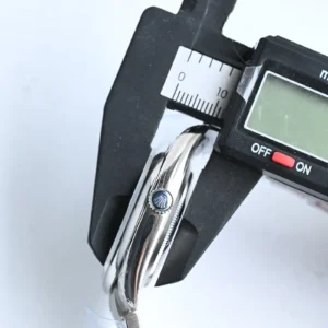 Rolex Oyster Perpetual watch silver dial stainless steel case and bezel close-up with measuring caliper