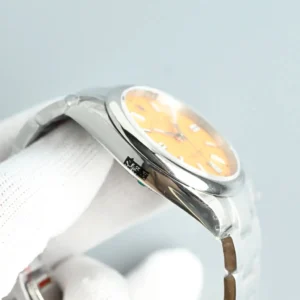 Rolex Oyster Perpetual 124300 orange dial stainless steel watch with smooth bezel and metal bracelet