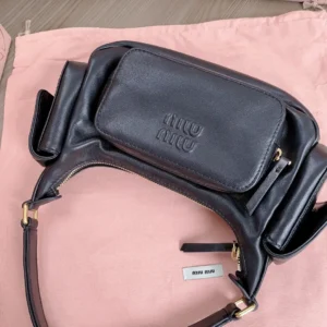 Miu Miu handbag small black leather with front zip pocket and gold hardware detailing