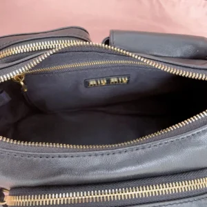 Miu Miu leather crossbody bag black gold-tone zipper detailed medium size leather bag interior view