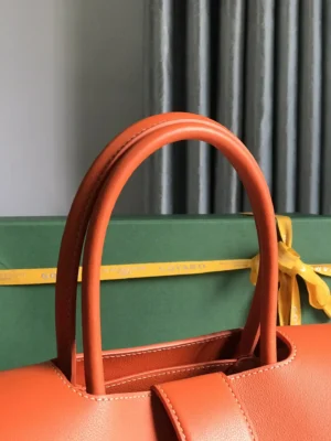 Goyard Artois 25 handbag orange leather with rolled handles and smooth texture