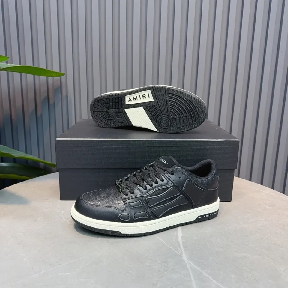 Amiri Low Top Sneakers black colorway leather material with embossed logo and white sole detailing