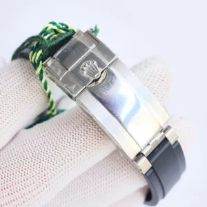 Rolex Oyster Perpetual watch clasp stainless steel with black rubber strap close-up detail