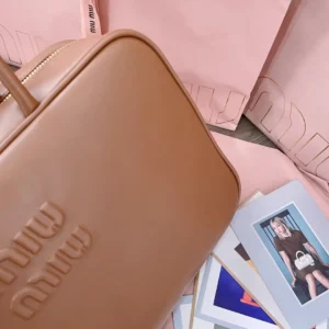 Miu Miu Leather Crossbody Bag medium brown smooth leather with embossed logo and gold zipper closure