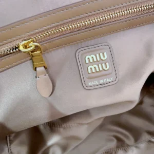 Miu Miu handbag beige nylon gold-tone zipper logo patch interior pocket luxury bag