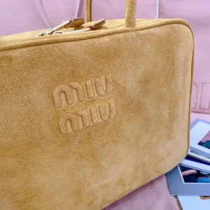 Miu Miu handbag medium tan suede bag with embossed logo and gold hardware zipper pull