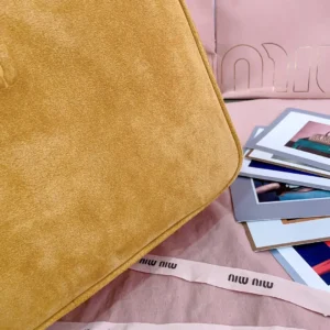 Miu Miu handbag medium tan suede bag with embossed logo and pink branded ribbon accents