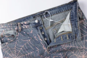 Repsgoat denim jeans blue fabric pink spider web pattern button fly pockets