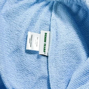 Denim Tears towel light blue cotton fabric made in Portugal with embroidered brand label