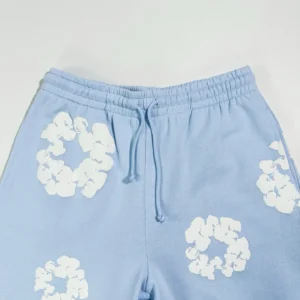 No brand or specific product details visible for this light blue shorts with white floral print and drawstring closure.