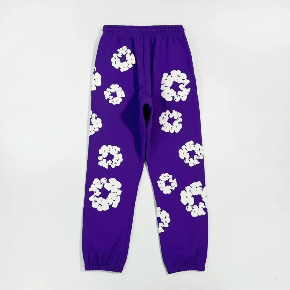 No brand specified for purple sweatpants with white floral patterns made of cotton material
