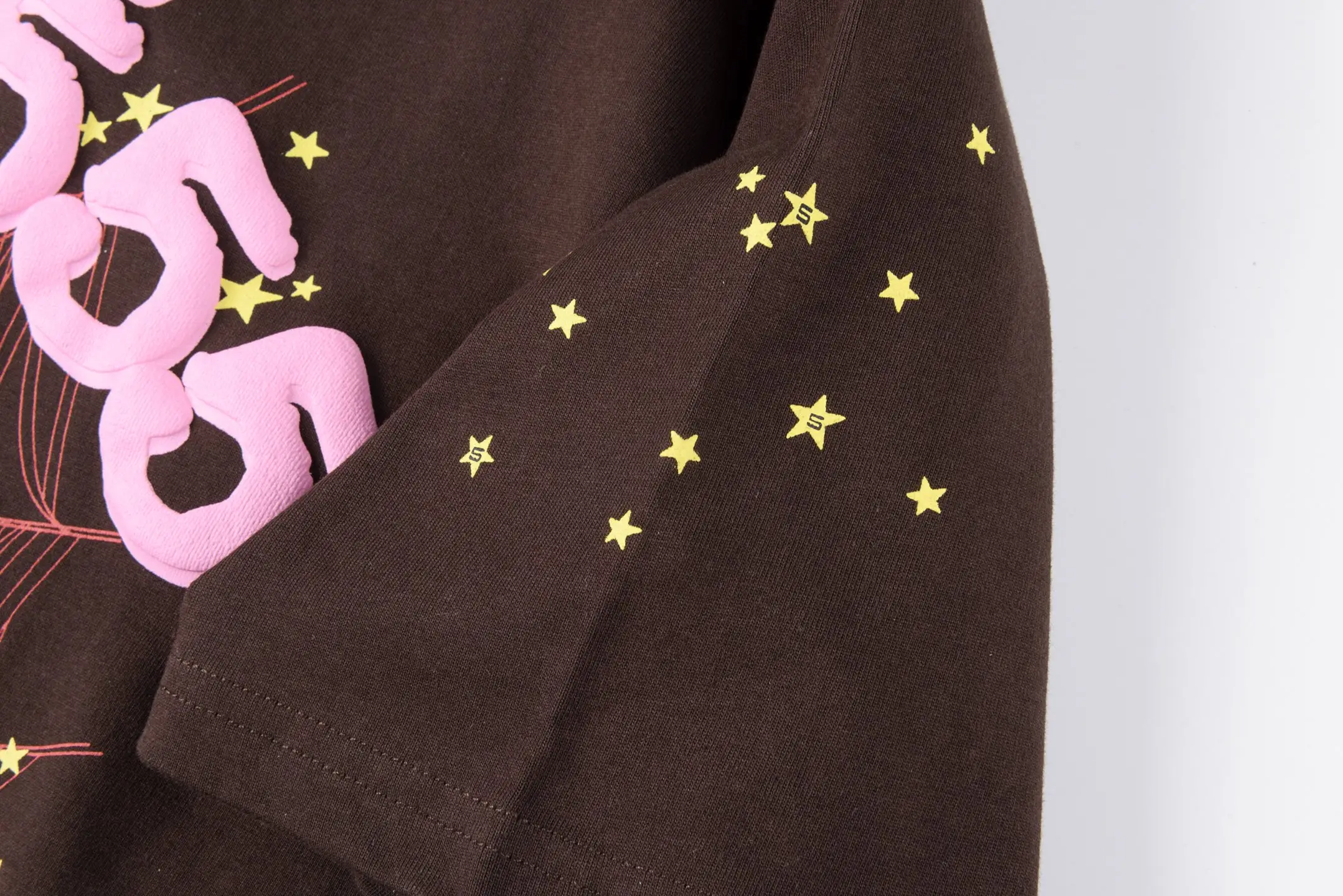 Supreme T-shirt brown cotton fabric with pink logo and yellow star graphic on sleeve