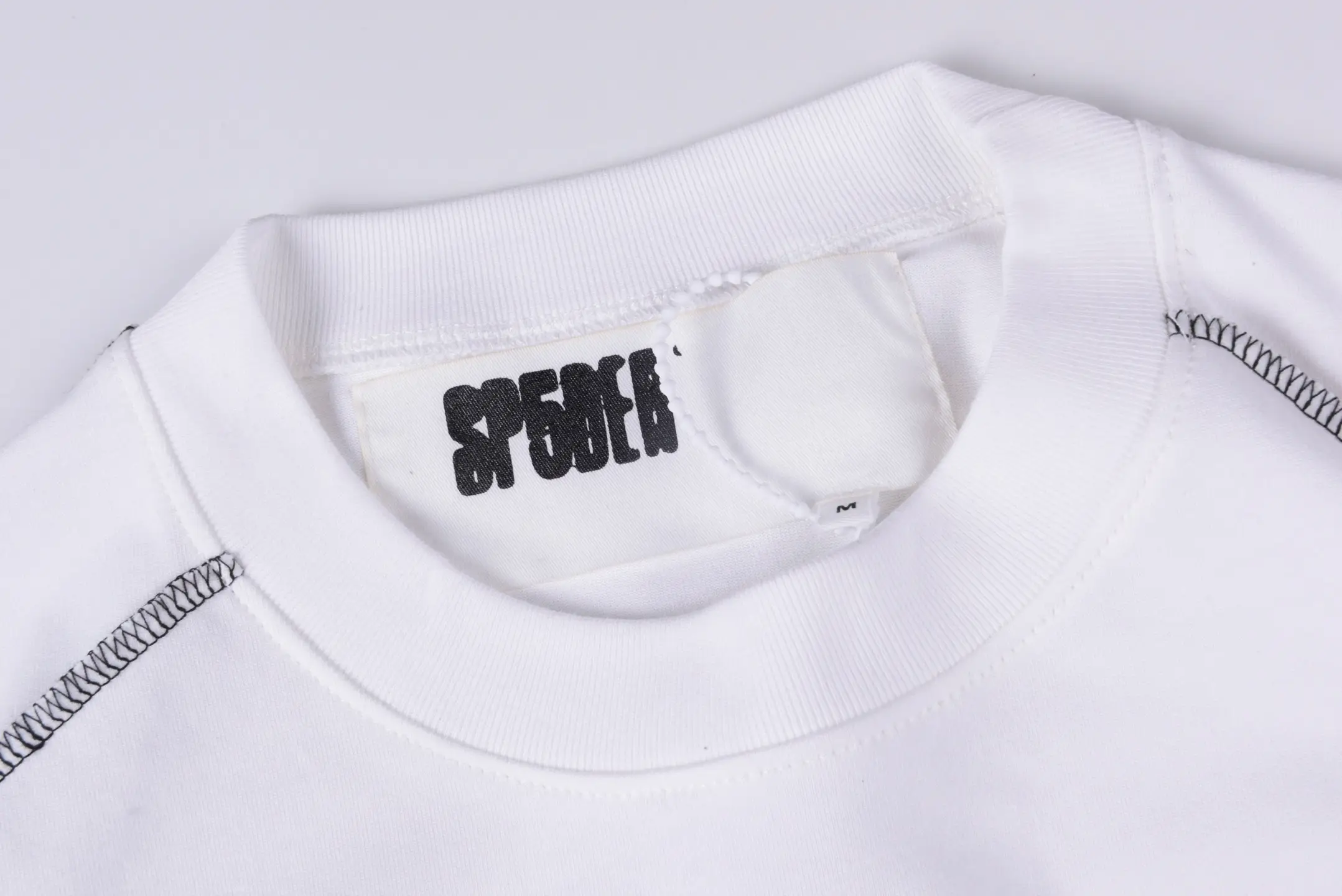 Supreme crewneck sweatshirt white cotton with black stitch detailing and printed logo tag inside neckline