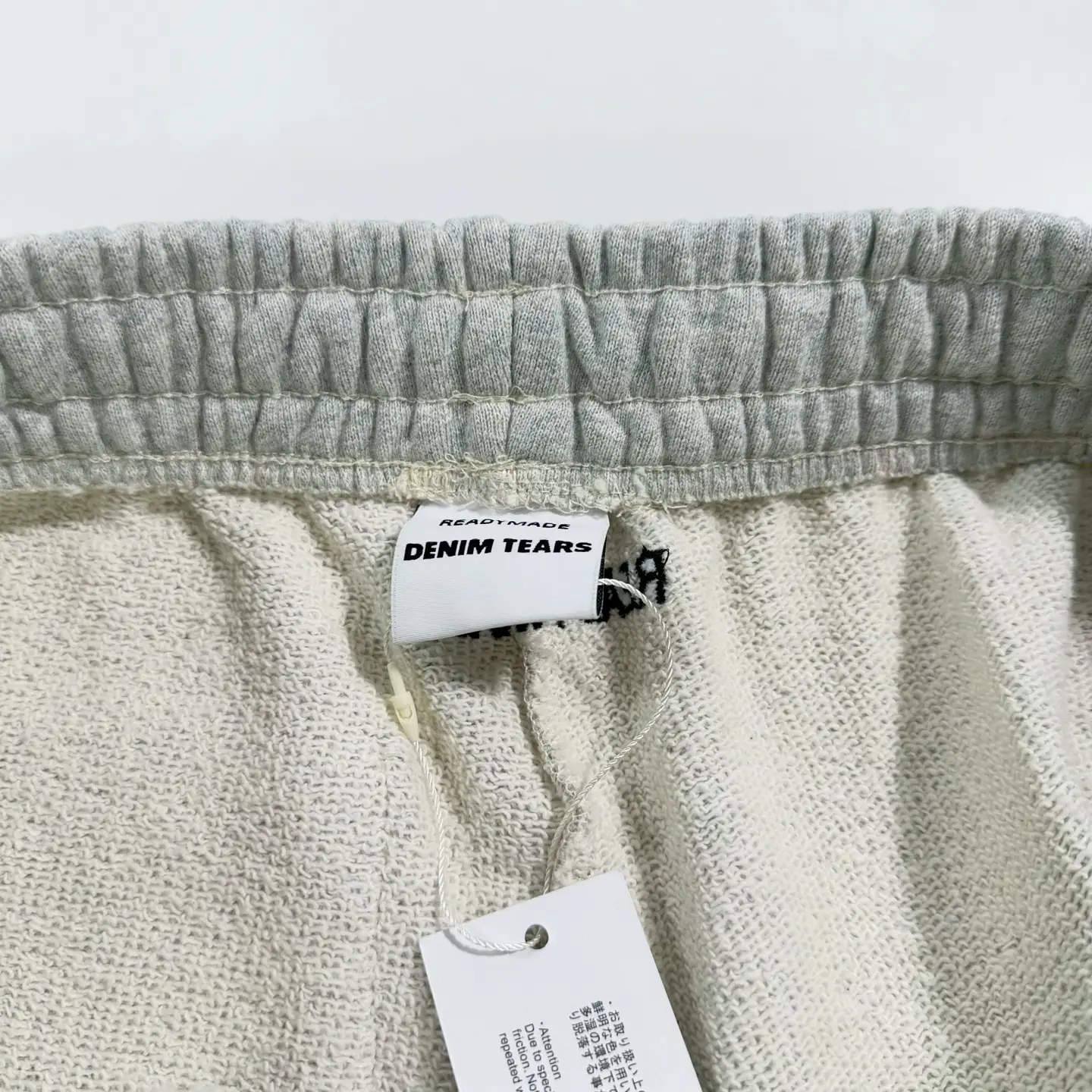 Readymade Denim Tears beige cotton blend sweatpants with elastic waistband and brand label