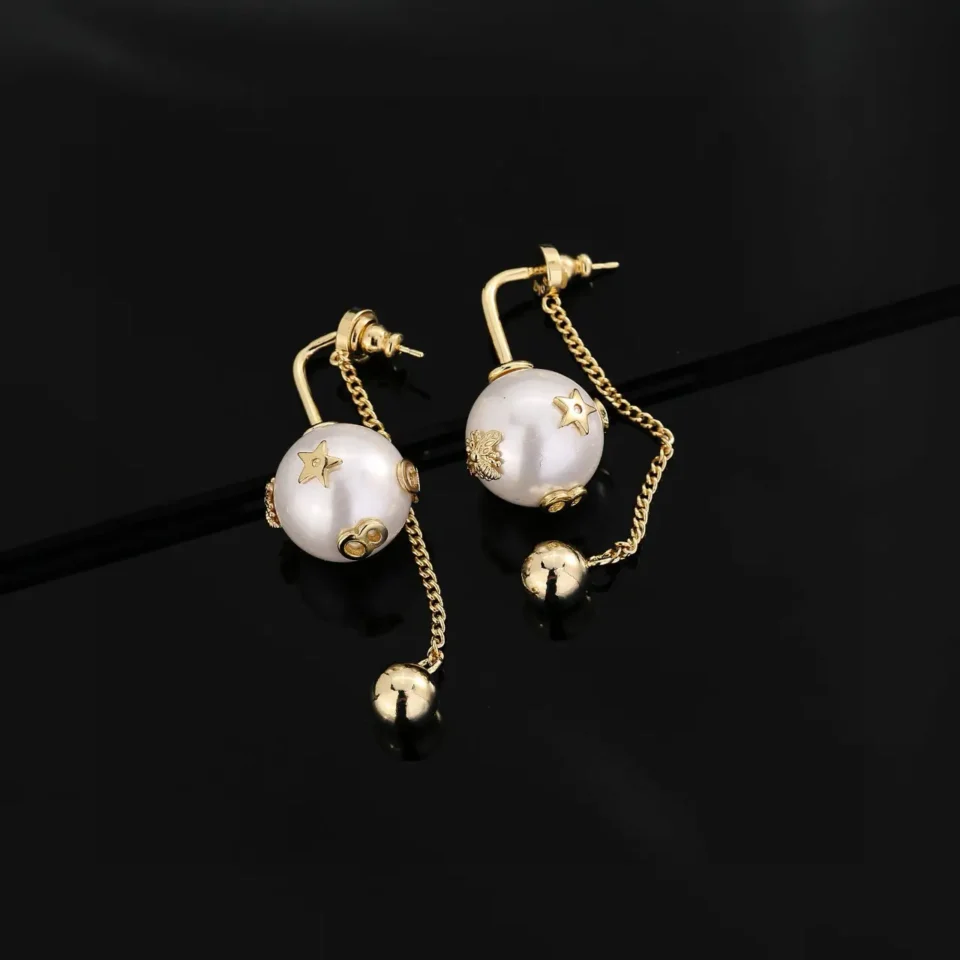 Unknown brand gold tone earrings white pearl dangle design with star and floral detailing metal chain