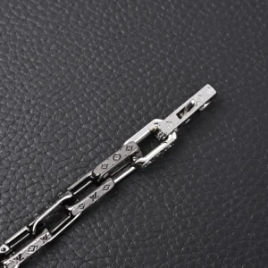Louis Vuitton bracelet silver metal chain link with LV monogram engraved design accessory