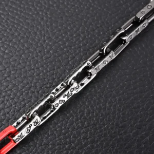 Louis Vuitton chain accessory silver metal with engraved monogram links and red details
