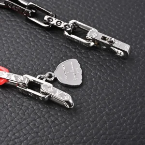 Louis Vuitton chain bracelet silver metal heart charm engraved detailing accessory
