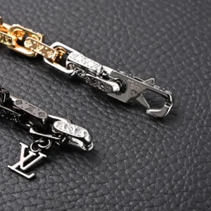 Louis Vuitton chain accessory gold and silver-tone metal with LV logo charm and engraved links