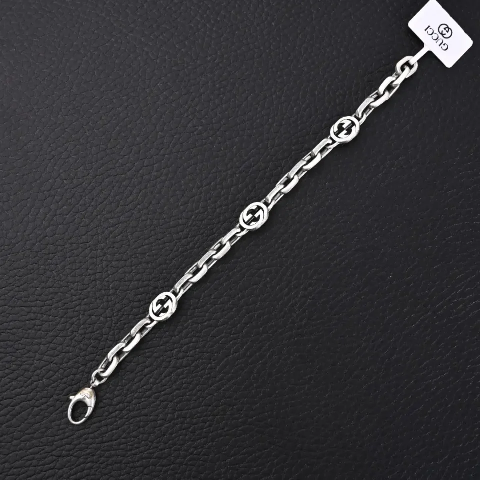 Gucci bracelet silver metal chain with interlocking G logo links and lobster clasp closure