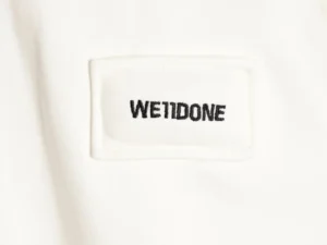 We11done clothing label white cotton fabric with black embroidered logo patch