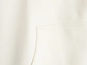 Repsgoat white cotton fabric close-up showing stitching and pocket detail