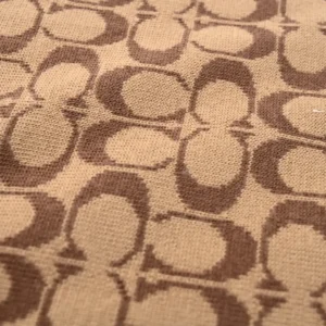 Coach fabric beige brown signature jacquard canvas material close-up texture