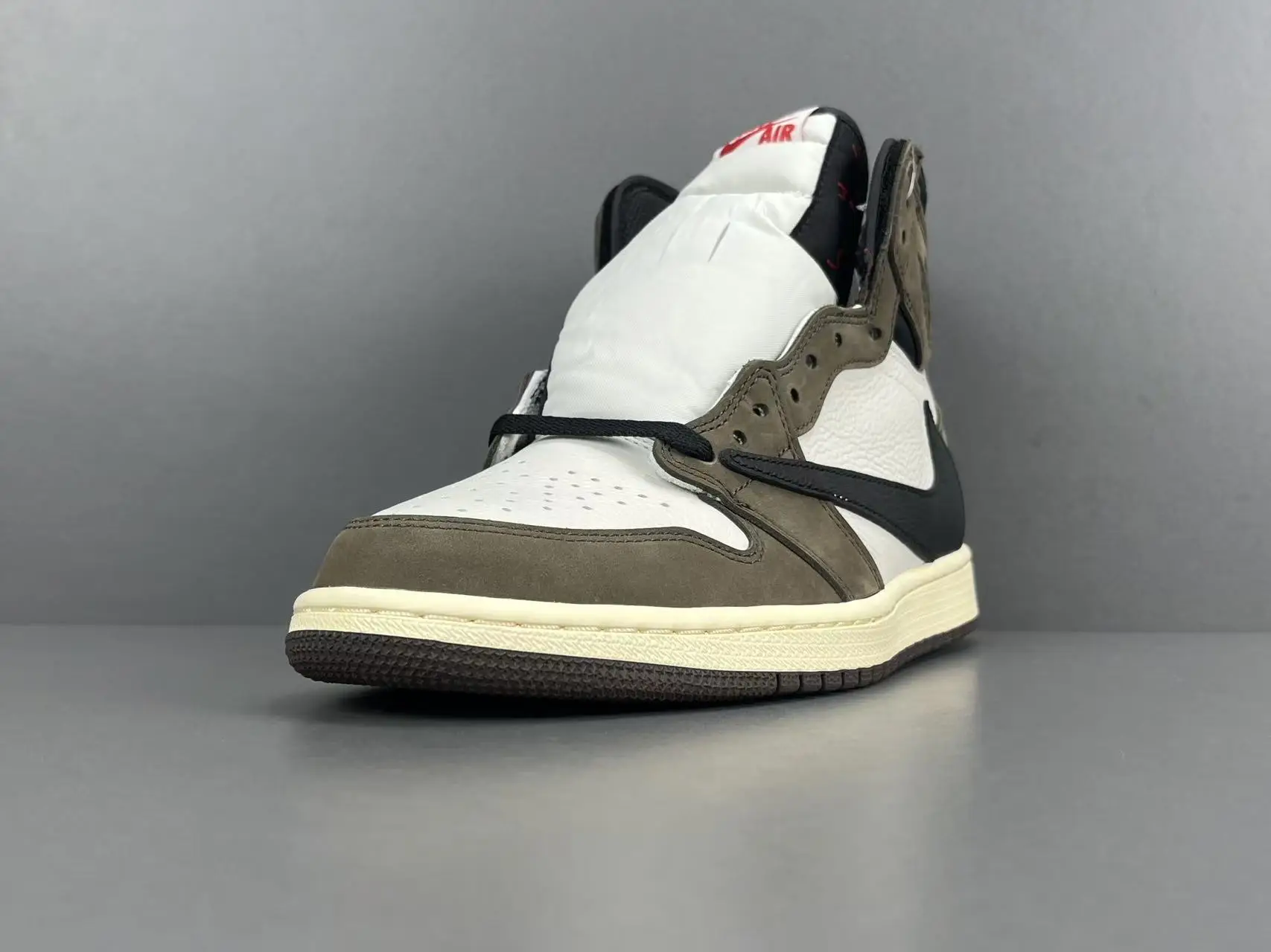 Nike Air Jordan 1 High OG Travis Scott white black brown leather sneakers with reversed swoosh