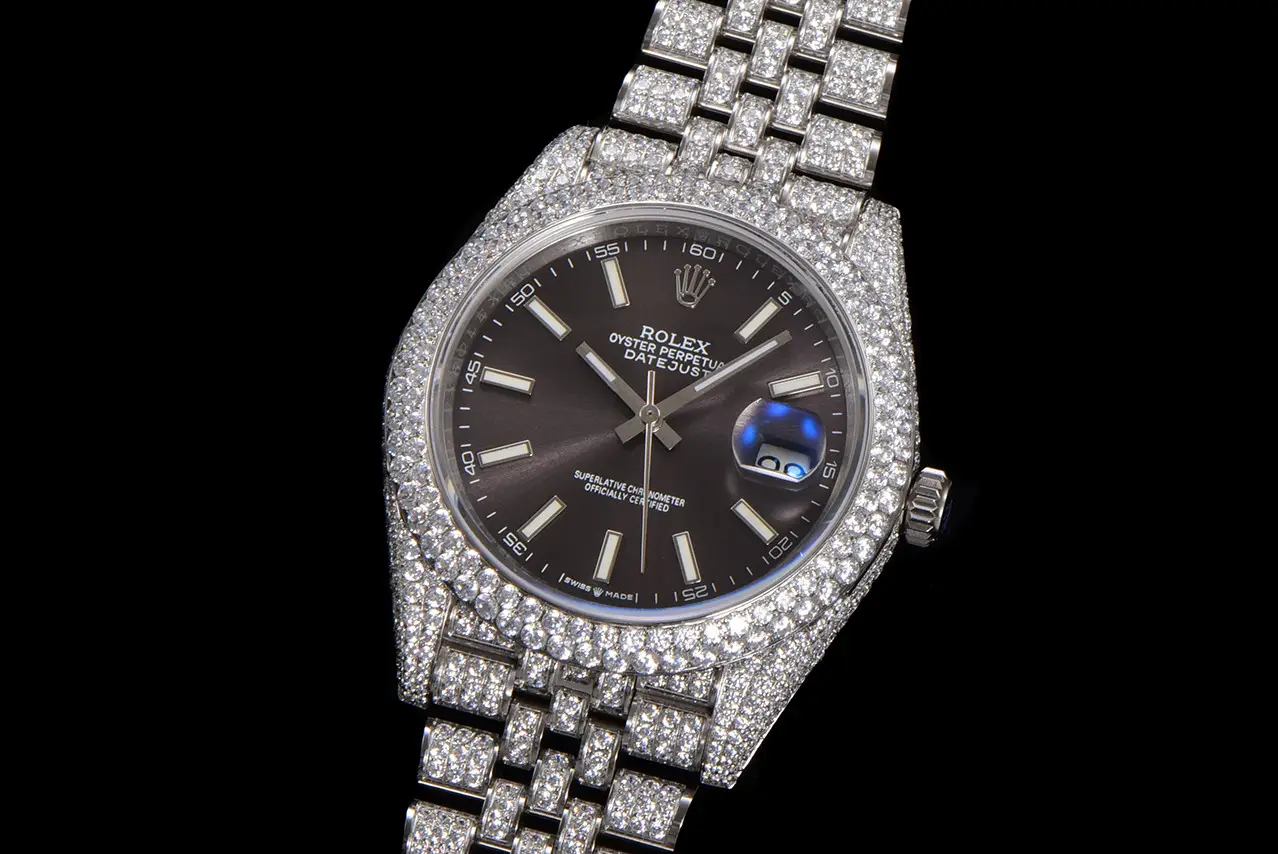 Diamond Rolex watch with black dial and jubilee bracelet, Datejust 41 “Iced Out” model on display.