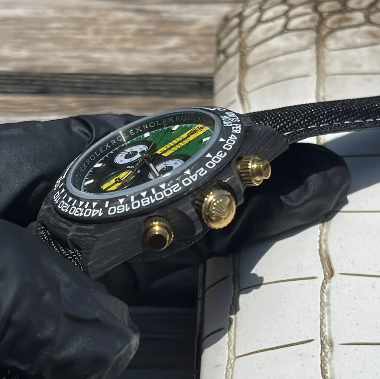 Black Rolex watch with colorful dial
