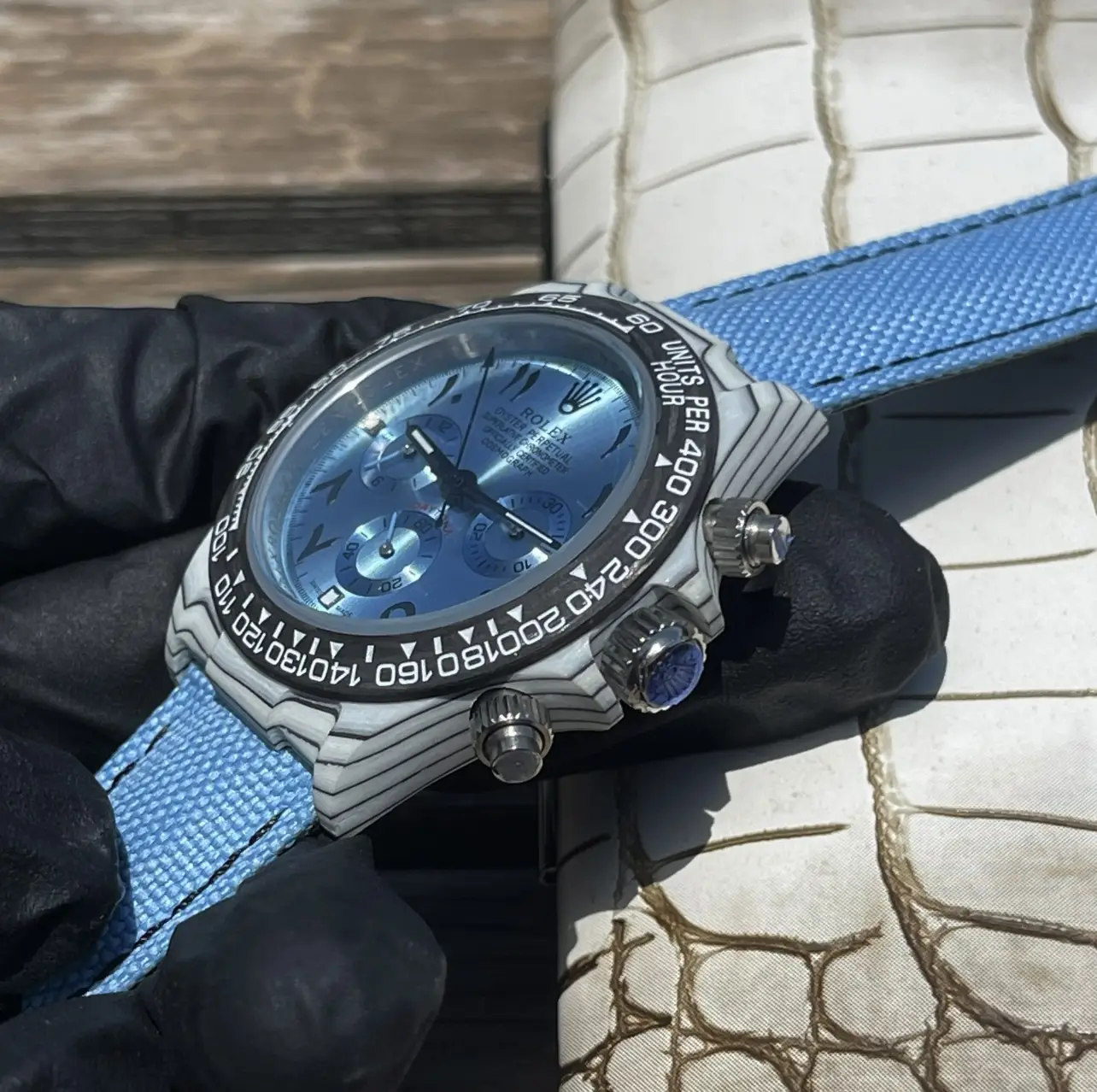 Stylish blue watch on textured strap